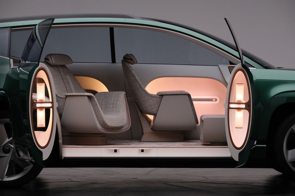 Lateral view of the hyundai three row Ev. It shows the suicide doors open.