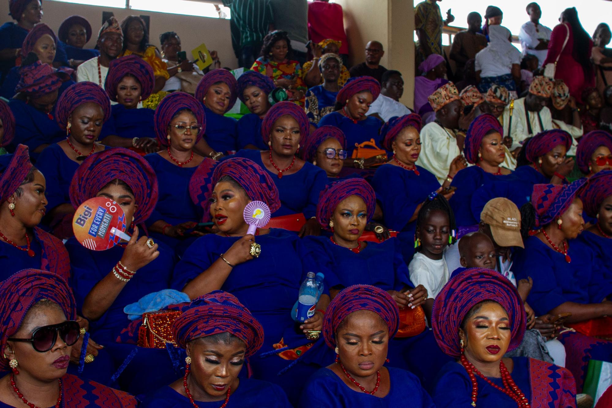 Women elegantly dressed in traditional Aso-Oke attire
