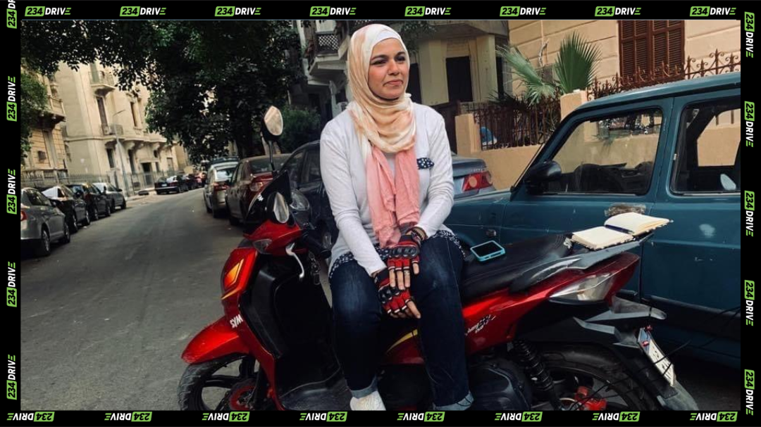 Woman sitting on a scooter in Arabic headtie in Egypt