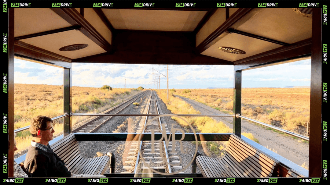Passengers sit on the open observation deck, watching the tracks stretch ahead as the scenery changes mile after mile. | Source: Rovos Rail
