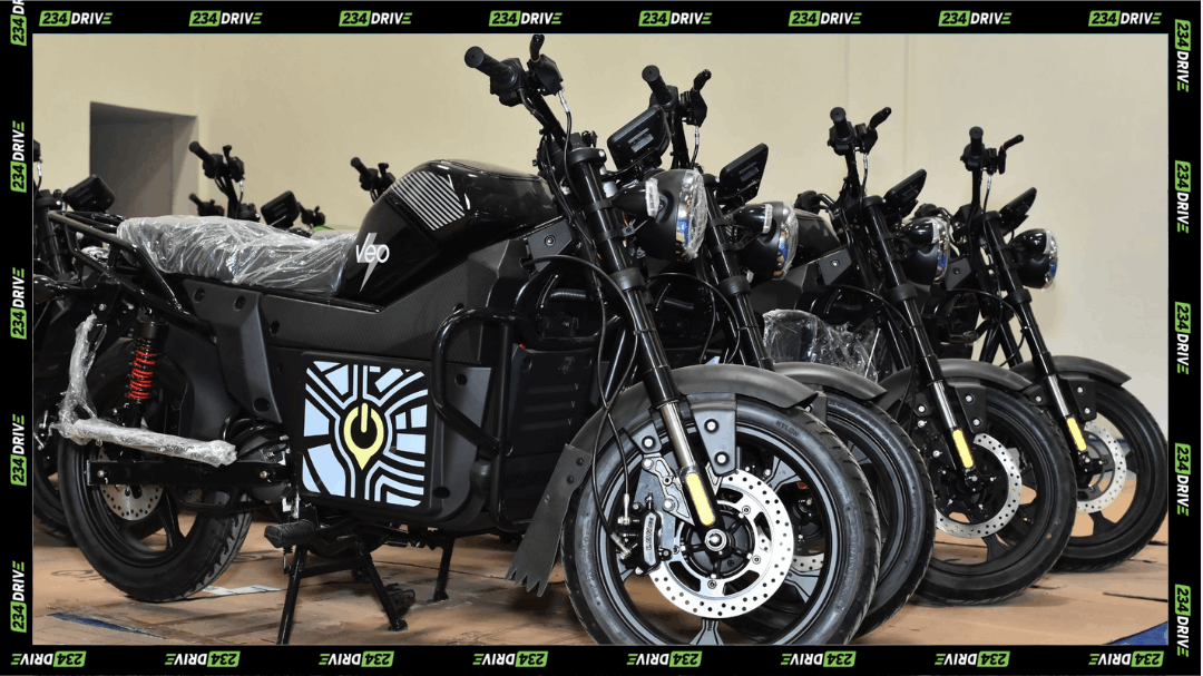 Rows of black Spiro electric motorcycles sit indoors, showing newly assembled bikes prepared for deployment across African mobility markets.