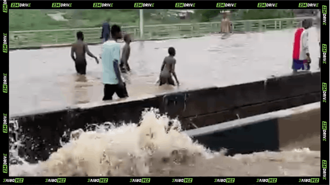 Floodwater across theOjota–Maryland Bridge as residents wade through the submerged Lagos crossing after heavy rain.
