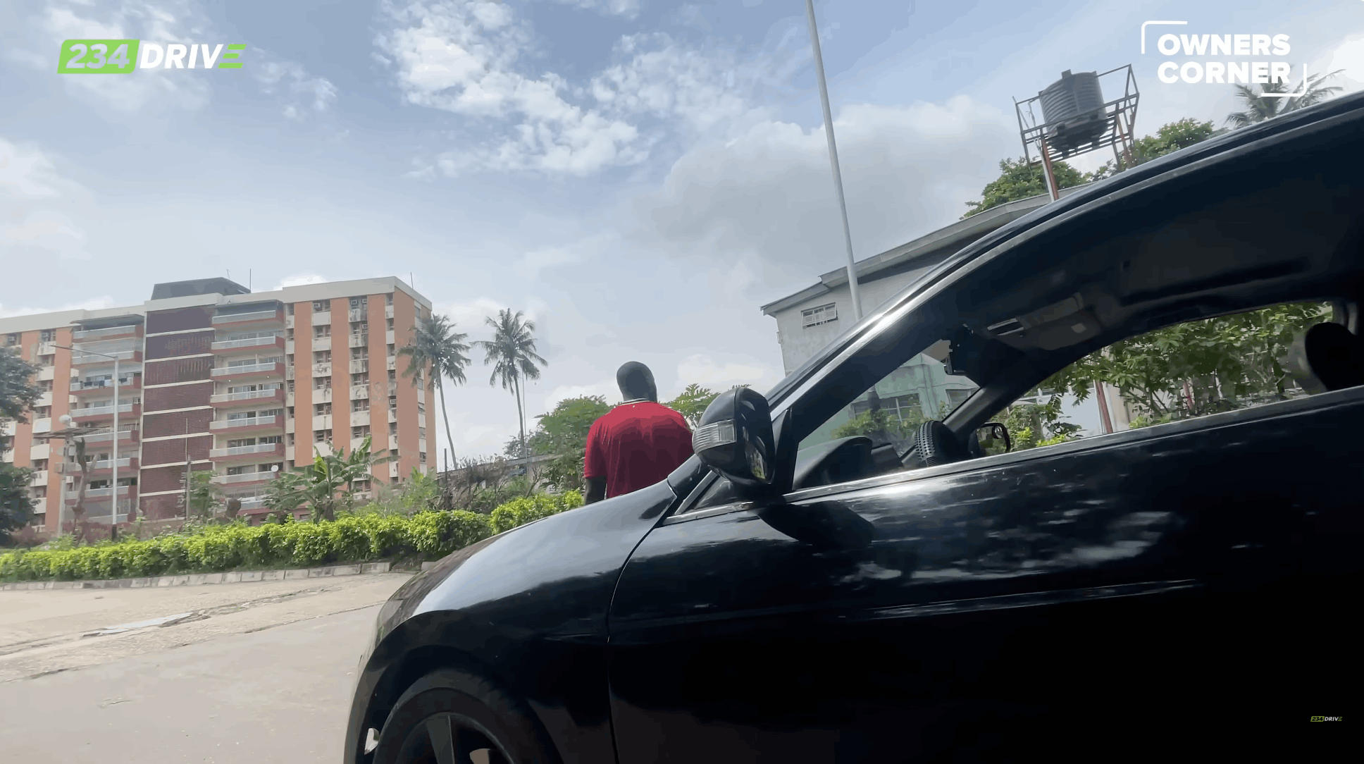 Man walks away from his black Honda Accord Coupe, capturing the moment a proud owner turns back to admire his car.