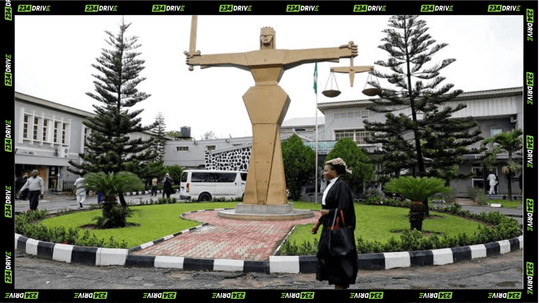 Lagos court complex with a lawyer walking past the Lady Justice statue during a major vehicle fraud investigation involving exotic cars.