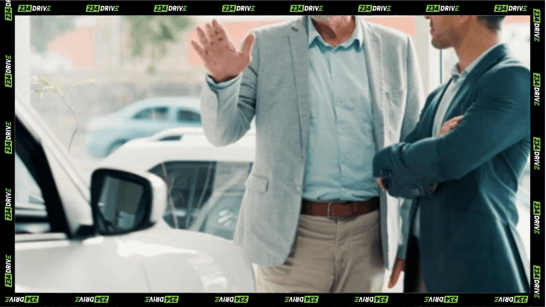 A car dealer discusses a vehicle with a potential buyer as dealership test-drive theft cases continue to draw attention.