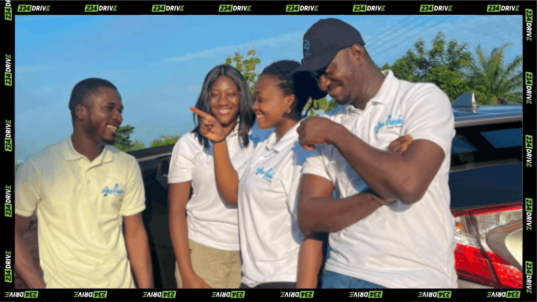 Four people wearing AkoFresh-branded shirts stand beside a vehicle outdoors, showing the team supporting the company’s cold-chain and rural mobility operations across Ghanaian communities.