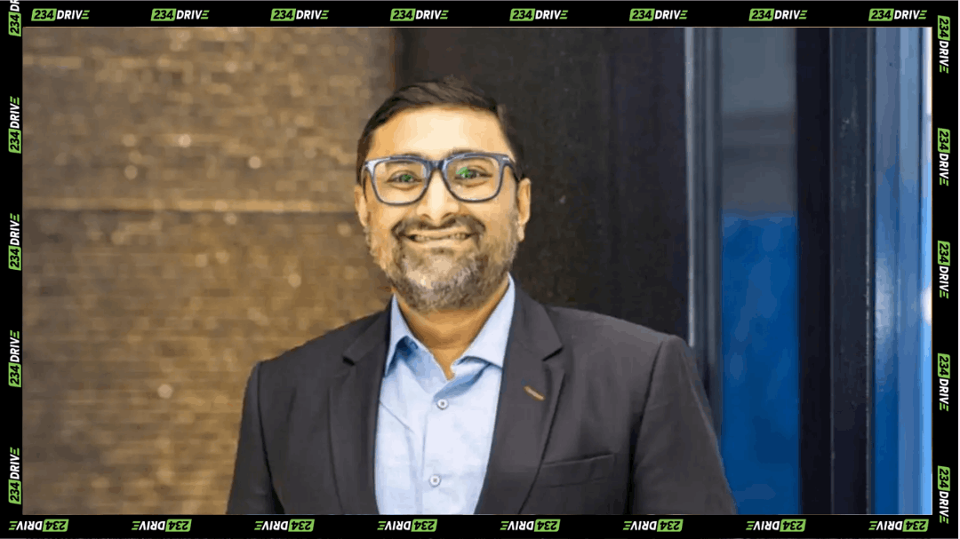 Auroasish Choudhuri, Spiro’s new Managing Director for West and Central Africa, stands indoors wearing glasses, a dark suit and light blue shirt.