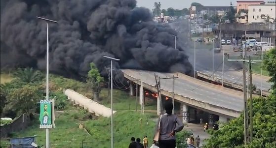 Thick black smoke rising beside Otedola Bridge in Lagos after a diesel tanker fell and caught fire