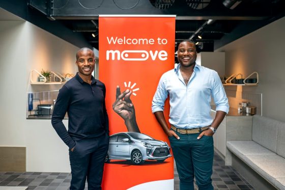 Moove executives standing in front of a Welcome to Moove banner