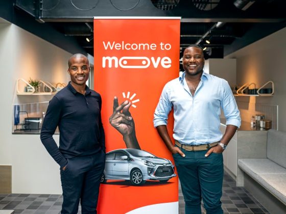Moove executives standing in front of a Welcome to Moove banner