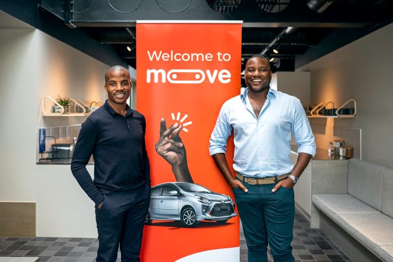 Moove executives standing in front of a Welcome to Moove banner