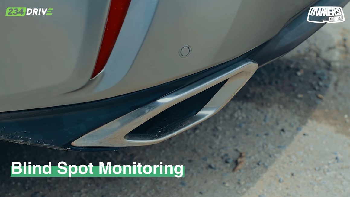 Rear bumper of the Lexus RX350 with a Blind Spot Monitoring label over the sensor area