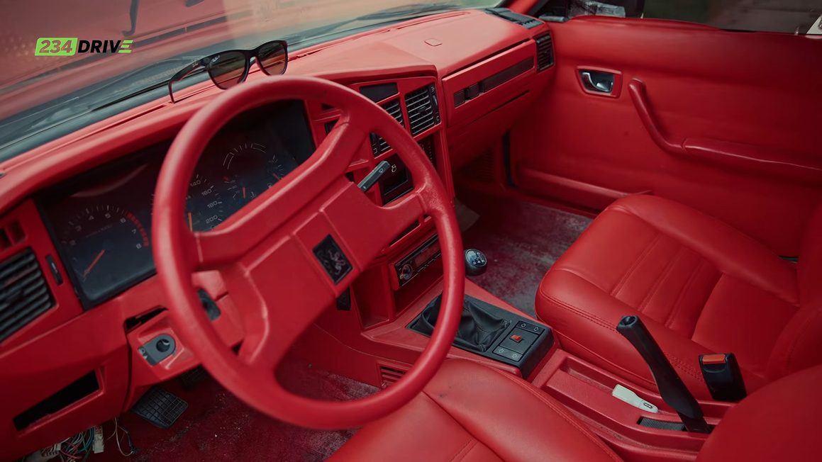 Custom red leather interior of Ameen's Peugeot 505 with steering wheel, dashboard and front seats