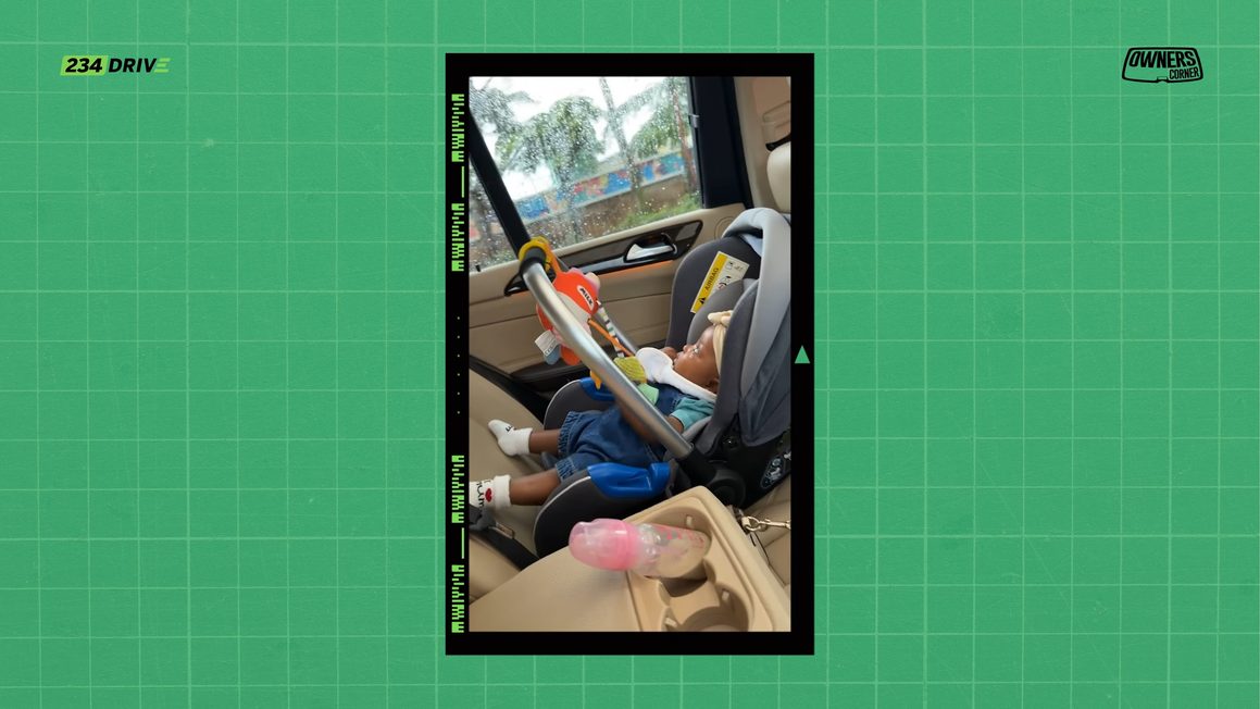 Baby asleep in an infant car seat in the back of Coco