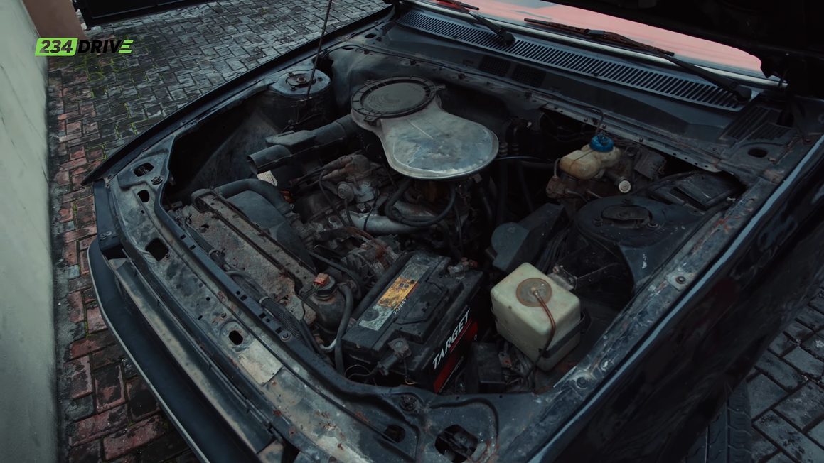 Open bonnet of Ameen's Peugeot 505 showing the two-litre engine bay